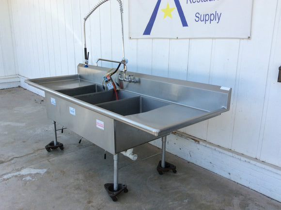 Three compartment sink with drainboards, drain levers, pull out sprayer, sanitizer dispenser and drainboards. Stainless Steel, commercial